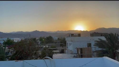 a view of a city with the sunset in the background at Luna House Lighthouse in Dahab