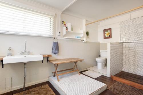 a bathroom with a sink and a toilet at Waipi'o Lodge in Kukuihaele