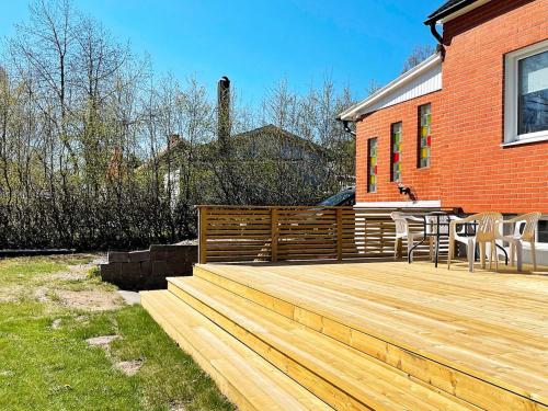 a wooden deck in front of a house at 5 person holiday home in Sibbhult-By Traum in Sibbhult