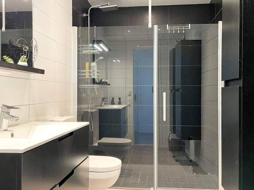 a bathroom with a shower and a toilet and a sink at 5 person holiday home in Sibbhult-By Traum in Sibbhult