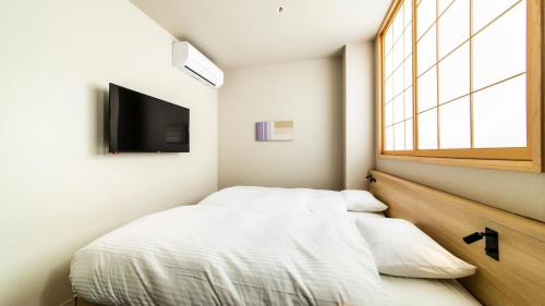 Postel nebo postele na pokoji v ubytování ALPHABED INN Fukuoka Ohori Park