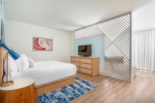 a bedroom with a white bed and a tv at Margaritaville Vacation Club by Wyndham Nashville in Nashville