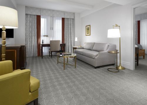 a living room with a couch and a table at InterContinental New York Barclay Hotel by IHG in New York