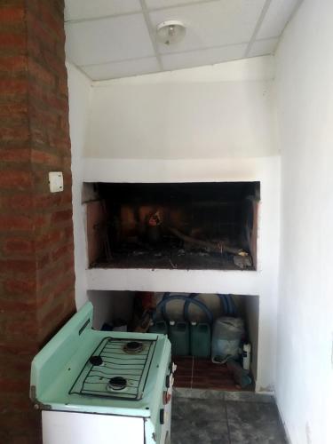 a green stove in a room with a fireplace at Don Castro Alojamiento Serrano in San Roque