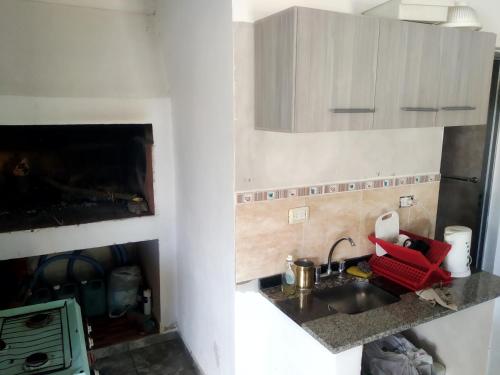 a small kitchen with a sink and a stove at Don Castro Alojamiento Serrano in San Roque