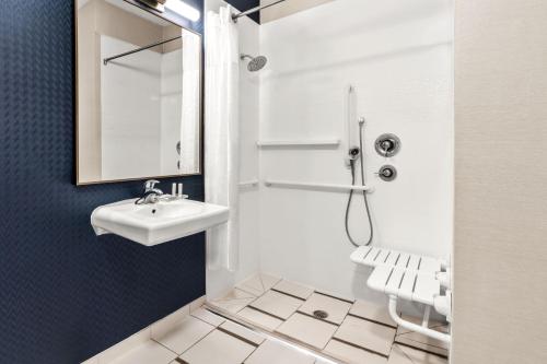 a white bathroom with a sink and a mirror at Fairfield Inn & Suites by Marriott San Antonio Downtown/Market Square in San Antonio