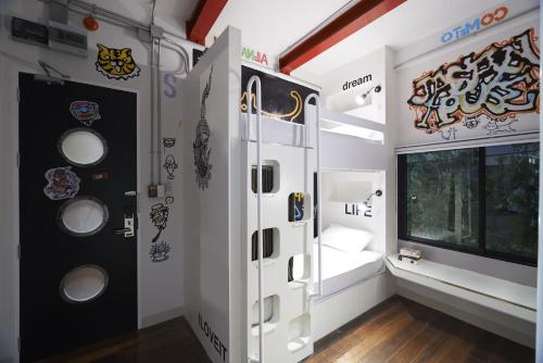 a room with a door with stickers on the wall at Jasaen Stylish Boutique Hotel in Bangkok