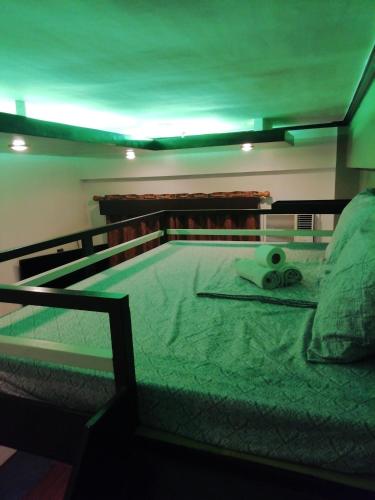 a bed with a pair of scissors on it at Condo near NAIA Terminals Fasanvej Studio Netflix in Manila