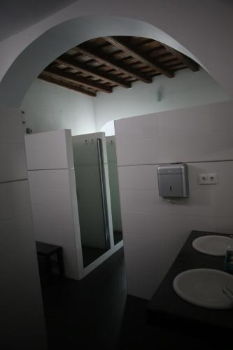 a bathroom with two sinks and a mirror at Wake up in Tarifa Hostel & Restaurant Lounge in Tarifa