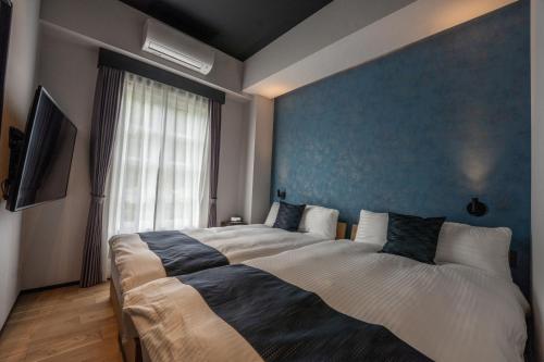Ein Bett oder Betten in einem Zimmer der Unterkunft Eau Sol Vert Karuizawa Club