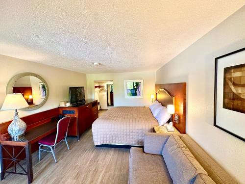a hotel room with a bed and a couch at Inn of Sheboygan in Sheboygan