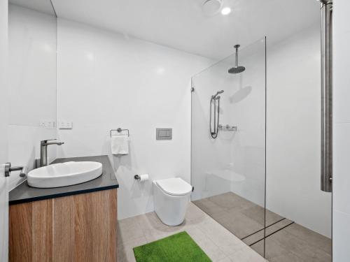 a bathroom with a sink and a toilet and a shower at Yuki Studio in Crackenback