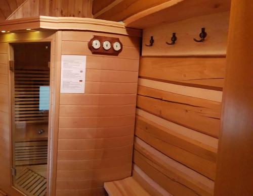 a walk in shower in a cabin with wood paneling at Holiday home in Jilove u Drzkova 1767 in Jílové u Držkova