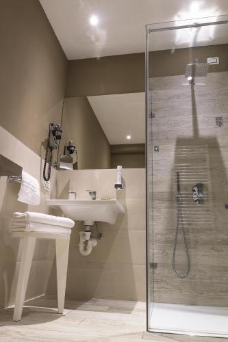 a bathroom with a sink and a shower at Hotel Relais Agli Olivi in Lazise