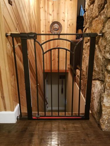 a spiral staircase in a room with a stone wall at Cedar Ridge Retreat Lake Almanor in Lake Almanor