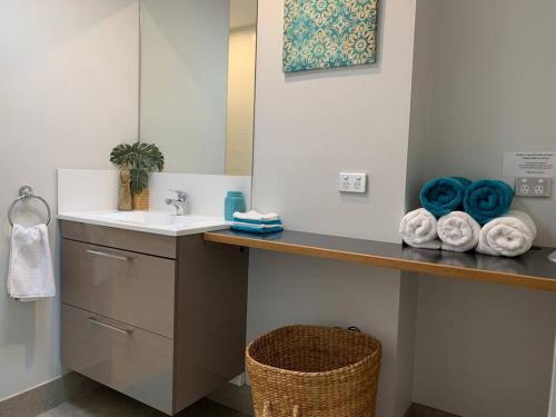 a bathroom with a sink and a counter with towels at Panda's Patch Dunsborough in Dunsborough