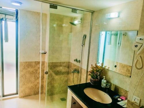 a bathroom with a sink and a shower at Hotel Crystal Rose - Sylhet in Sylhet