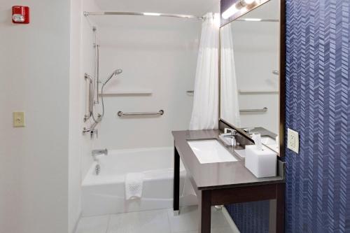 a bathroom with a sink and a tub and a shower at Fairfield by Marriott Youngstown/Austintown in Youngstown
