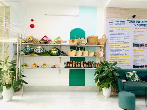 a store with shoes on shelves in a room at Pao Hotel in Hue