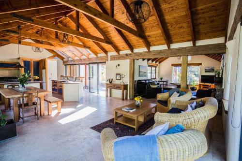 a large living room with couches and a table at The River House Wanaka in Wanaka
