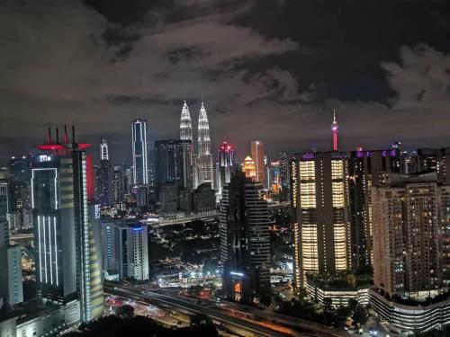 a night view of a large city with tall buildings at ExpressionZ Suites KLCC by EC in Kuala Lumpur