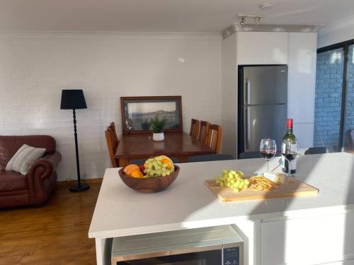 a kitchen with a bowl of fruit on a table at Jindabyne Lake View in Jindabyne