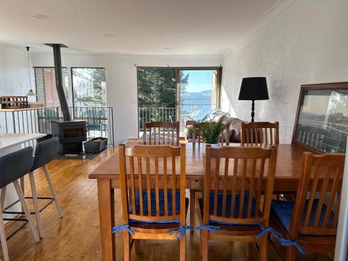a dining room with a wooden table and chairs at Jindabyne Lake View in Jindabyne