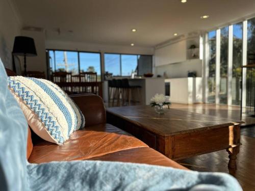 a living room with a couch and a coffee table at Jindabyne Lake View in Jindabyne