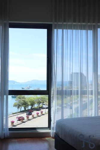 a bedroom with a bed and a window with a view at Homesuite' Home at The Loft in Kota Kinabalu