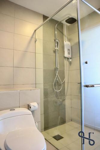a bathroom with a shower and a toilet at Homesuite' Home at The Loft in Kota Kinabalu