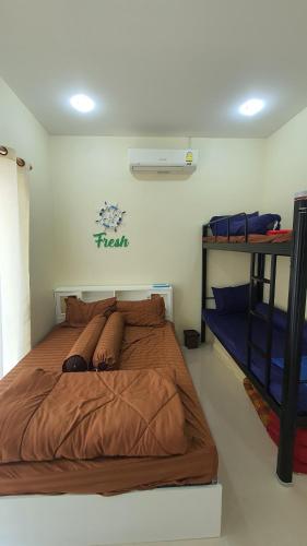 a bedroom with a large bed in a room at Family POOL VILLA CHAAM in Cha Am