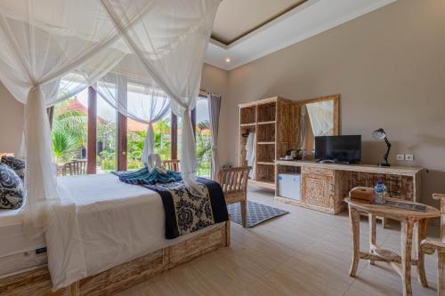 a bedroom with a bed and a television and a table at Favorit Exclusive Villa & Bungalow in Nusa Penida