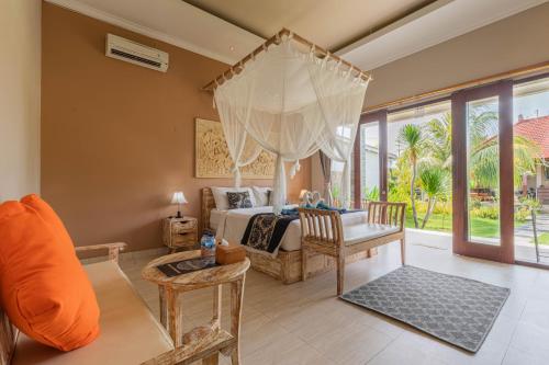 a bedroom with a bed and a living room at Favorit Exclusive Villa & Bungalow in Nusa Penida