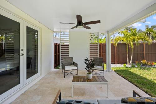 a living room with a ceiling fan and a patio at Newly Remodeled House in Miami - 3BR House with Private Yard - 5 Min ride to Hollywood Beach in Hollywood