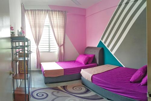 two beds in a room with pink walls at DG HomestayMuslim Putrajaya - Near Alamanda in Putrajaya