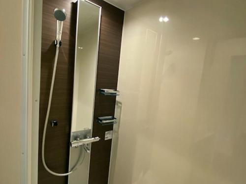 a bathroom with a shower with a mirror at Crest Asago in Asago