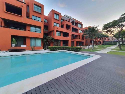 an apartment complex with a swimming pool in front of a building at Las Tortugas, Cozy condominium on Khao Tao beach, Hua Hin in Khao Tao