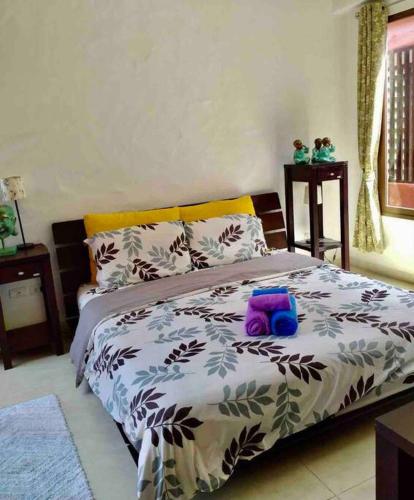 a bed with a purple stuffed animal on top of it at Las Tortugas, Cozy condominium on Khao Tao beach, Hua Hin in Khao Tao