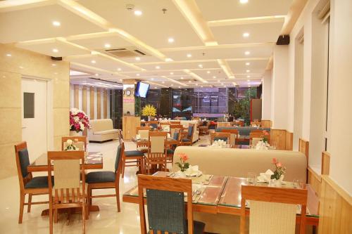a restaurant with tables and chairs and a dining room at Shara Hotel Da Nang in Da Nang