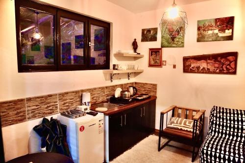 a kitchen with a sink and a refrigerator in a room at Jarmenovci Glamping Resort in Jarmenovci