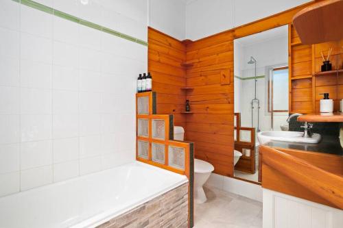 a bathroom with a white toilet and a sink at 2-bedroom Cottage in Redcliffe - 6A in Redcliffe