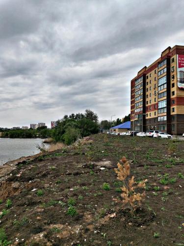 a building on the shore of a body of water at Абая 244 in Uralsk