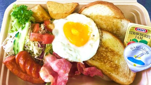 a plate of breakfast food with an egg and toast at Marea Resort Motobu in Motobu