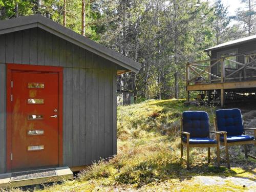 two blue chairs sitting outside of a small building at 4 person holiday home in UDDEVALLA in Uddevalla