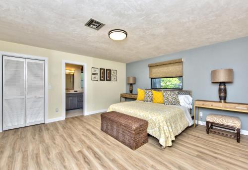 a bedroom with a bed and a table and a desk at Avanti Vacation Rental in Naples