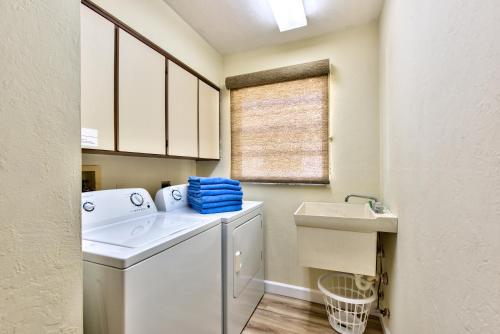 a laundry room with a washing machine and a sink at Avanti Vacation Rental in Naples