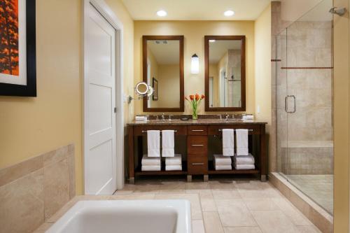 a bathroom with a tub and a sink and a shower at The Westin Riverfront Mountain Villas, Beaver Creek Mountain in Avon