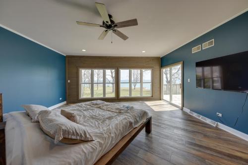 a bedroom with a large bed and a ceiling fan at Lake Michigan Vacation Rental with Private Beach! in Racine