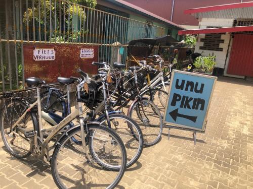 a row of bikes parked next to a sign at Unu Pikin Guesthouse in Paramaribo
