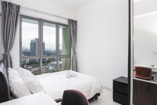 Ένα ή περισσότερα κρεβάτια σε δωμάτιο στο Tropics Condo